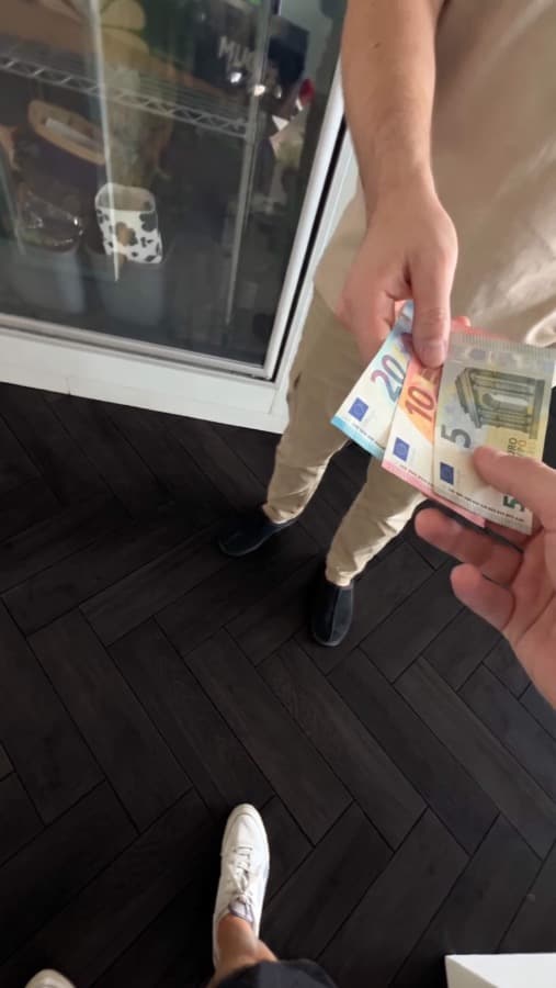 A Google review card on a shop counter, tapped with a phone (3)